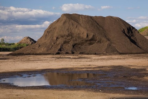 Mound of topsoil in a commercial sandpit after a heavy rainfall