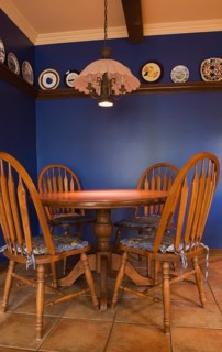 Antique table and chairs in the kitchen of a 1998 reproduction of an old Canadiana cottage style residential Home