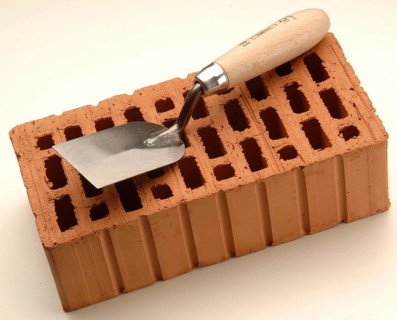 Smoothing trowel on a red brick