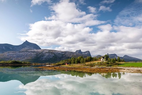 Mountains and landscape reflected in fjord