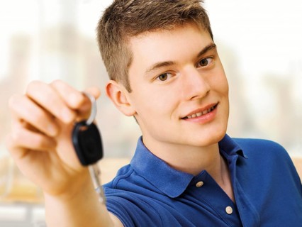 Teenager holding car keys after passing a driving test
