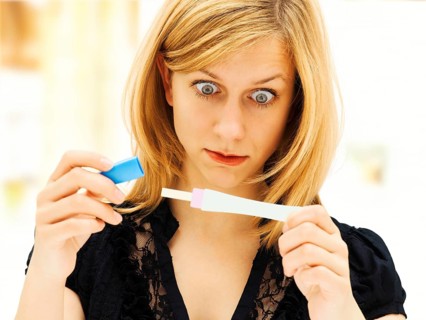 Woman holding a pregnancy test