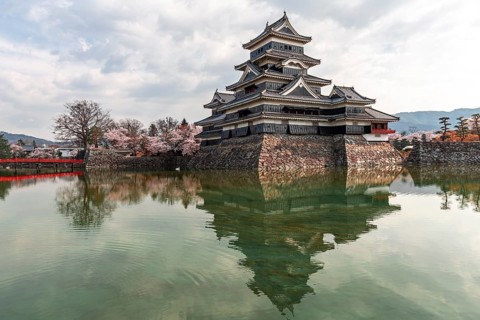 Old Japanese castle reflected in the moat