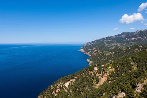 View of the cliffs with a remote house near Estellencs