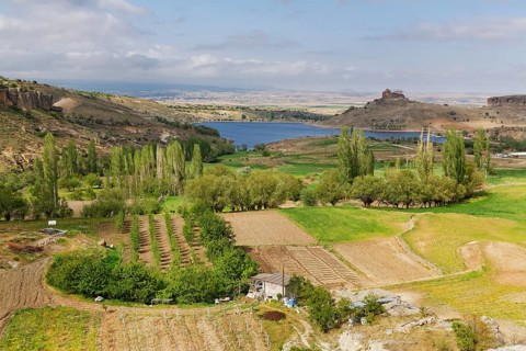Fields and Yuksek Kilise or High Church at Guzelyurt