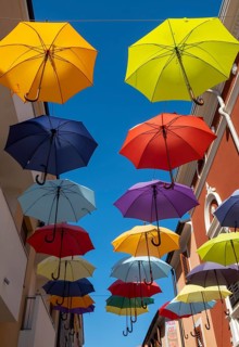Colorful umbrellas over a road