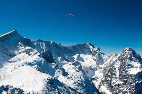 Paraglider pilot in front of Zugspitze and Waxenstein