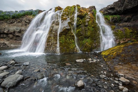 Fossarett waterfall with river Fossa at fjord Hvalfjorour