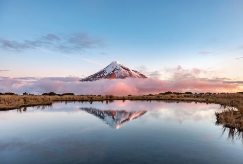 Water reflection in Pouakai Tarn Mountain Lake at sunset