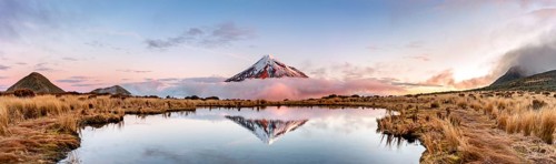 Water reflection in Pouakai Tarn Mountain Lake at sunset