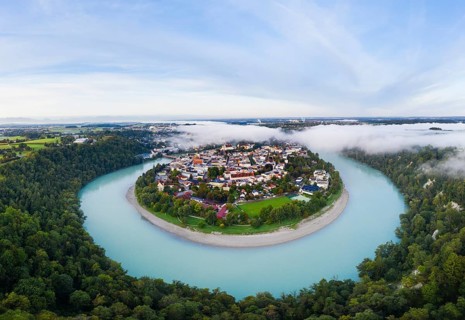 Old town in river bend of the Inn with fog