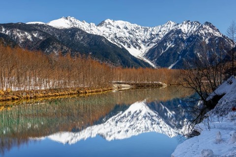 Snow-covered mountains at a lake