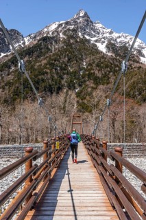 Woman walking over Myojin Bridge