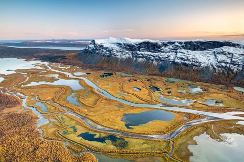 View from mountain Skierffe to the autumnal river delta Rapadalen