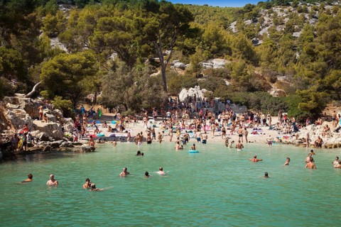 Beach vacationers at the beach in the bay Calanque de Port-Pin