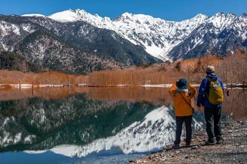 Two Japanese tourists at a lake