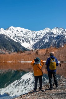 Two Japanese tourists at a lake