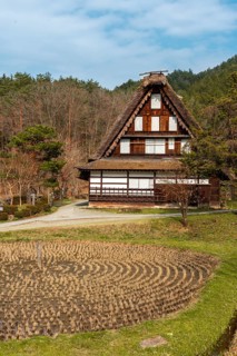Round rice field with farmhouse