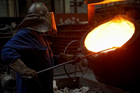 Worker on tanks with liquid iron