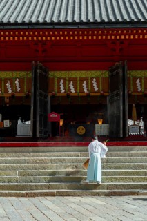 Monk sweeping a staircase with a broom
