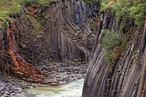 Studlagil gorge with basalt columns and glacial river Jokulsa a Bru