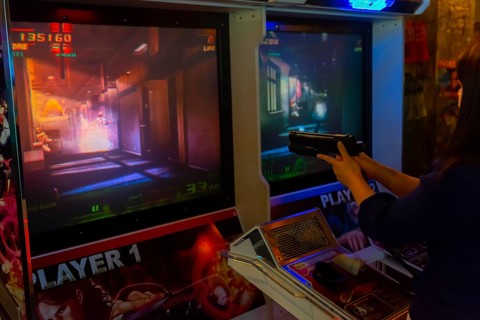Person holds gun to control a computer game
