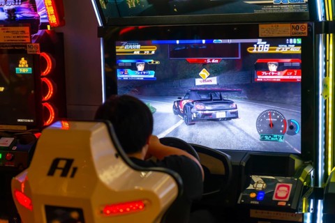 Teenager plays a car racing game