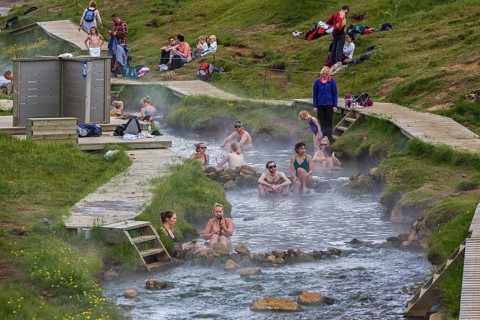Bathing people in the hot thermal springs Reykjadalur