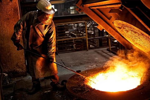 Worker on tanks with liquid iron