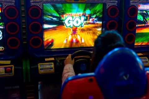 Teenager plays a car racing game