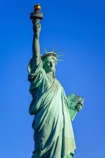 Statue of Liberty in front of blue sky