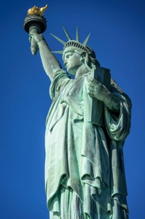 Statue of Liberty in front of blue sky