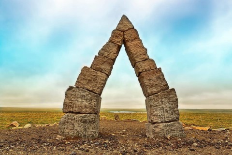 Monumental stone gate in barren landscape