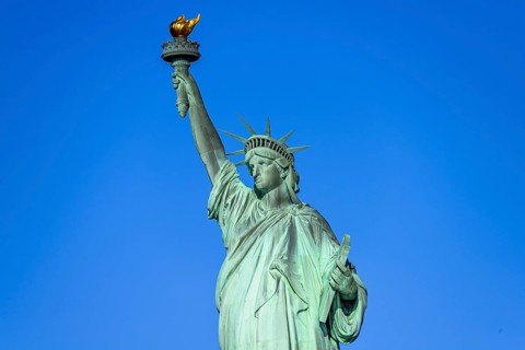 Statue of Liberty in front of blue sky