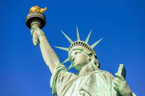 Statue of Liberty in front of blue sky