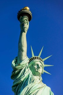Statue of Liberty in front of blue sky
