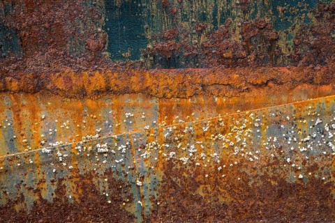 Rusty hull with barnacles