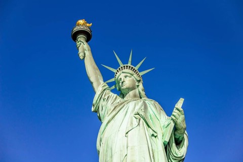 Statue of Liberty in front of blue sky