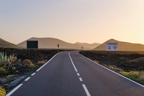 Country road through lava field in evening light