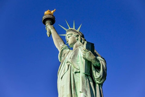 Statue of Liberty in front of blue sky