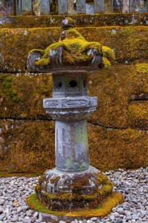 Moss-covered stone candelabra