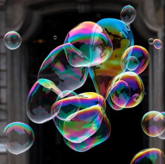 Large soap bubbles fly through the air