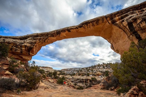 Tourist under rock arch
