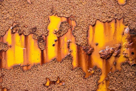 Rust on yellow metal wall