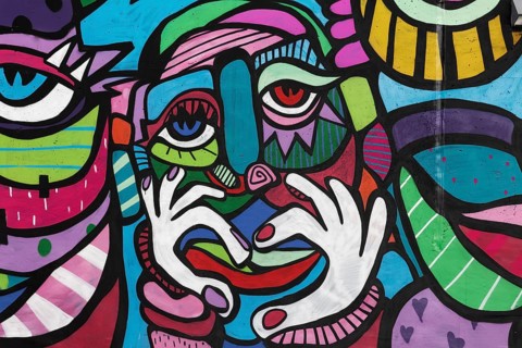 Colourful face with hand signal heart