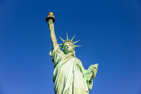 Statue of Liberty in front of blue sky