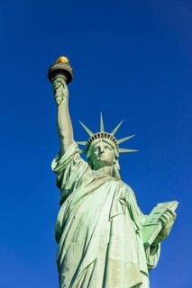 Statue of Liberty in front of blue sky