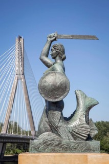 Bronze sculpture of the Warsaw mermaid on the bank of the Vistula River