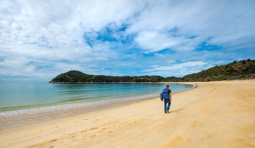 Young man walks on the beach