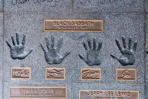 Hands of the band Black Sabbath with Geezer ButlerTony Iommi